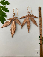 real cannabis leaf earrings electroplated with recycled copper 14 karat gold by simple wealth art made in usa