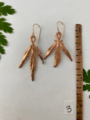 real cannabis leaf earrings electroplated with recycled copper 14 karat gold by simple wealth art made in usa