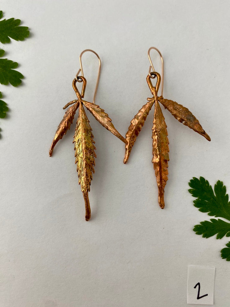 real cannabis leaf earrings electroplated with recycled copper 14 karat gold by simple wealth art made in usa