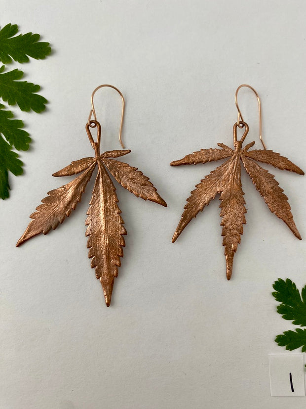 real cannabis leaf earrings electroplated with recycled copper 14 karat gold by simple wealth art made in usa