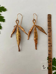 real cannabis leaf earrings electroplated with recycled copper 14 karat gold by simple wealth art made in usa